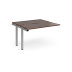 Modular bench desk add-on with a walnut top, integrated cable access cut-out, and  silver metal legs, shown on a white background.