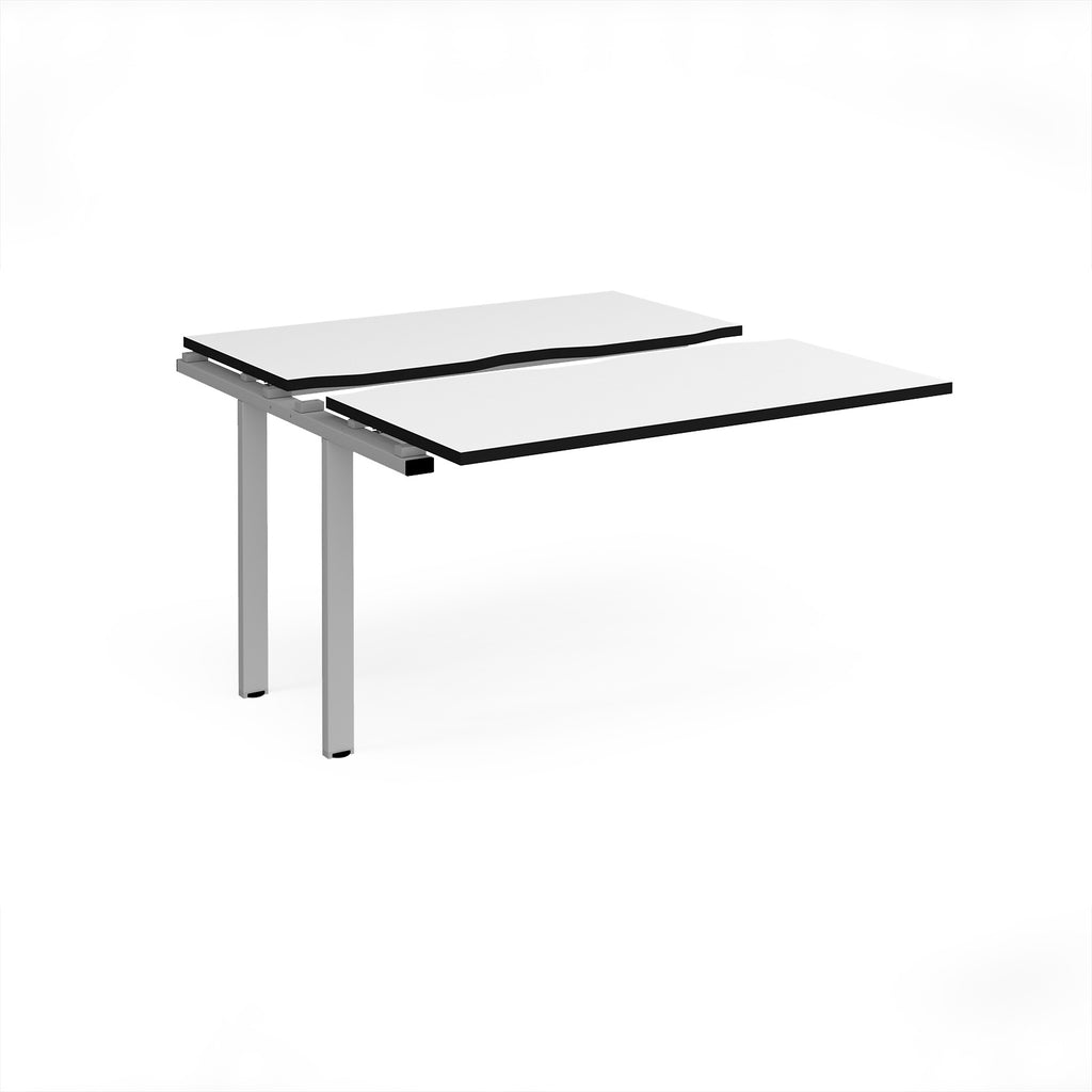 Modular bench desk add-on with a white top with black edging, integrated cable access cut-out, and white metal legs, shown on a white background.