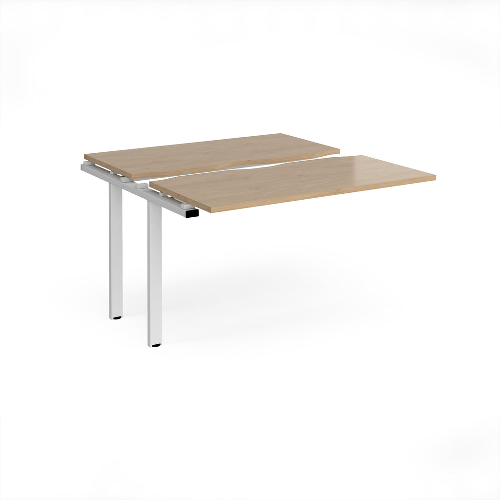 Modular bench desk add-on with a wood-effect top, integrated cable access cut-out, and white metal legs, shown on a white background.