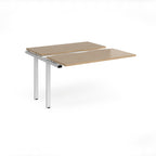 Modular bench desk add-on with a wood-effect top, integrated cable access cut-out, and white metal legs, shown on a white background.