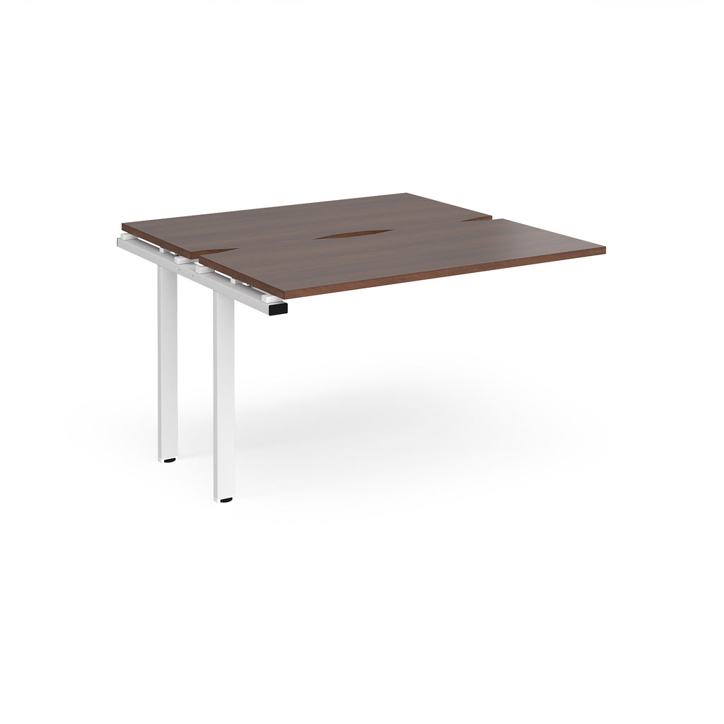 Modular bench desk add-on with a dark wood-effect top, integrated cable access cut-out, and white metal legs, shown on a white background.