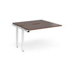 Modular bench desk add-on with a dark wood-effect top, integrated cable access cut-out, and white metal legs, shown on a white background.