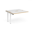 Modular bench desk add-on with white top with wood-effect edging, integrated cable access cut-out, and white metal legs, shown on a white background.