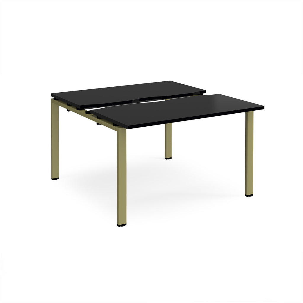 Two-person back-to-back office desk with black worktops and green metal legs, shown against a white background.