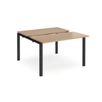 Two-person back-to-back office desk with wood-effect worktops and black metal legs, designed for shared workspace layouts.