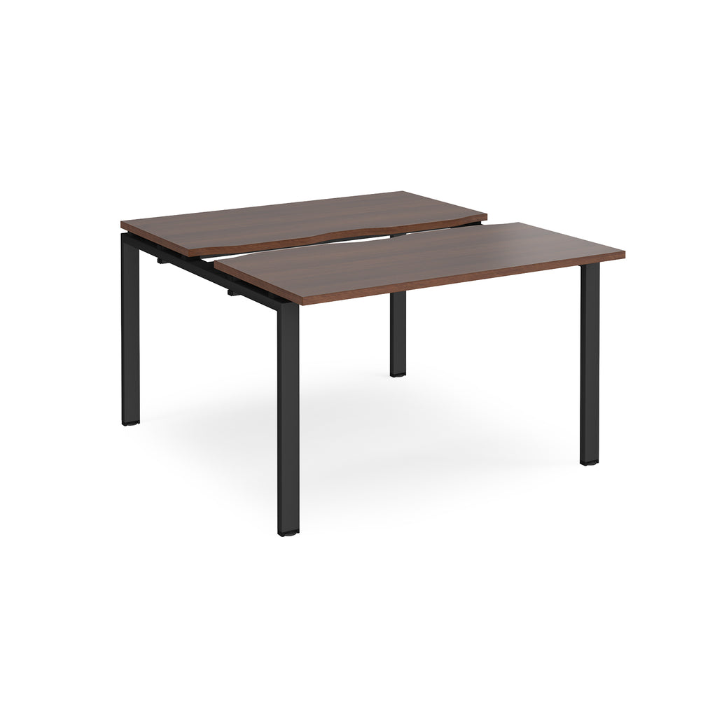 Two-person back-to-back office desk with dark wood-effect worktops and black metal legs, designed for shared workspace layouts.