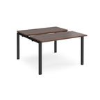 Two-person back-to-back office desk with dark wood-effect worktops and black metal legs, designed for shared workspace layouts.