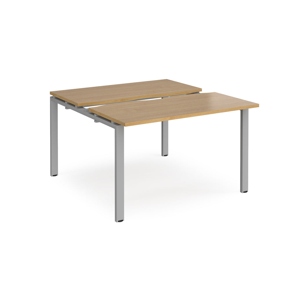 Two-person back-to-back office desk with oak-effect worktops and silver metal legs, designed for shared workspace layouts.
