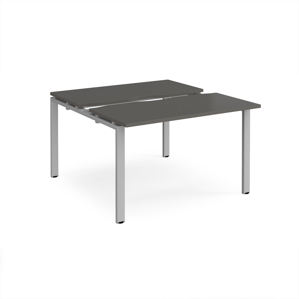 Two-person back-to-back office desk with grey worktops and silver metal legs, shown against a white background.
