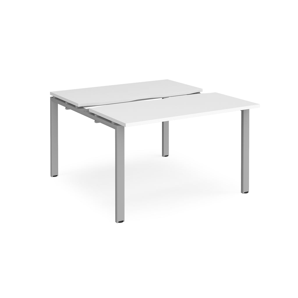 Two-person back-to-back office desk with white worktops and silver metal legs, shown against a white background.