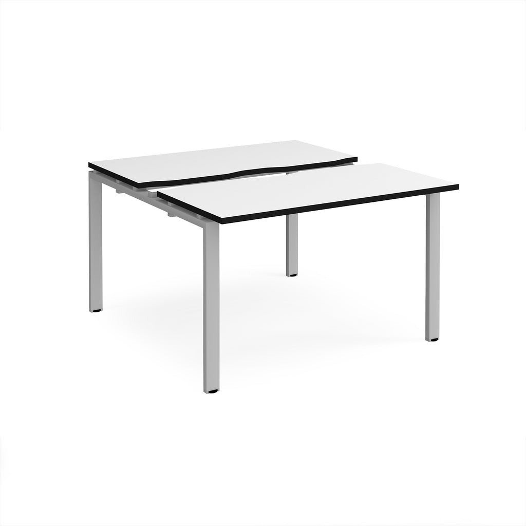 Two-person back-to-back office desk with white worktops, black edging, and silver metal legs, shown against a white background.