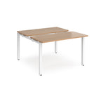 Two-person back-to-back office desk with wood-effect worktops and white metal legs, designed for shared workspace layouts.
