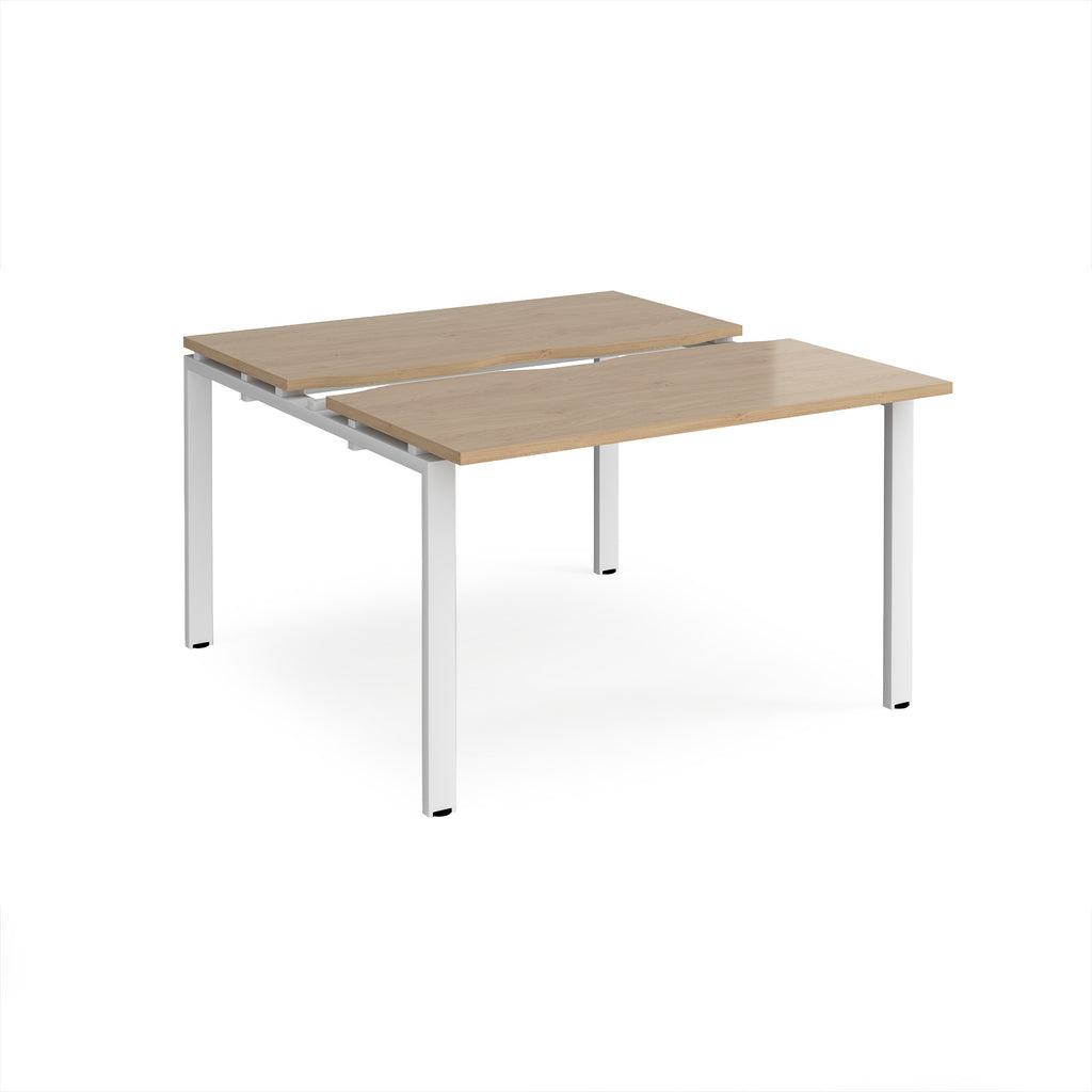 Two-person back-to-back office desk with oak-effect worktops and white metal legs, shown against a white background.