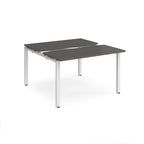 Two-person back-to-back office desk with grey worktops and white metal legs, shown against a white background.