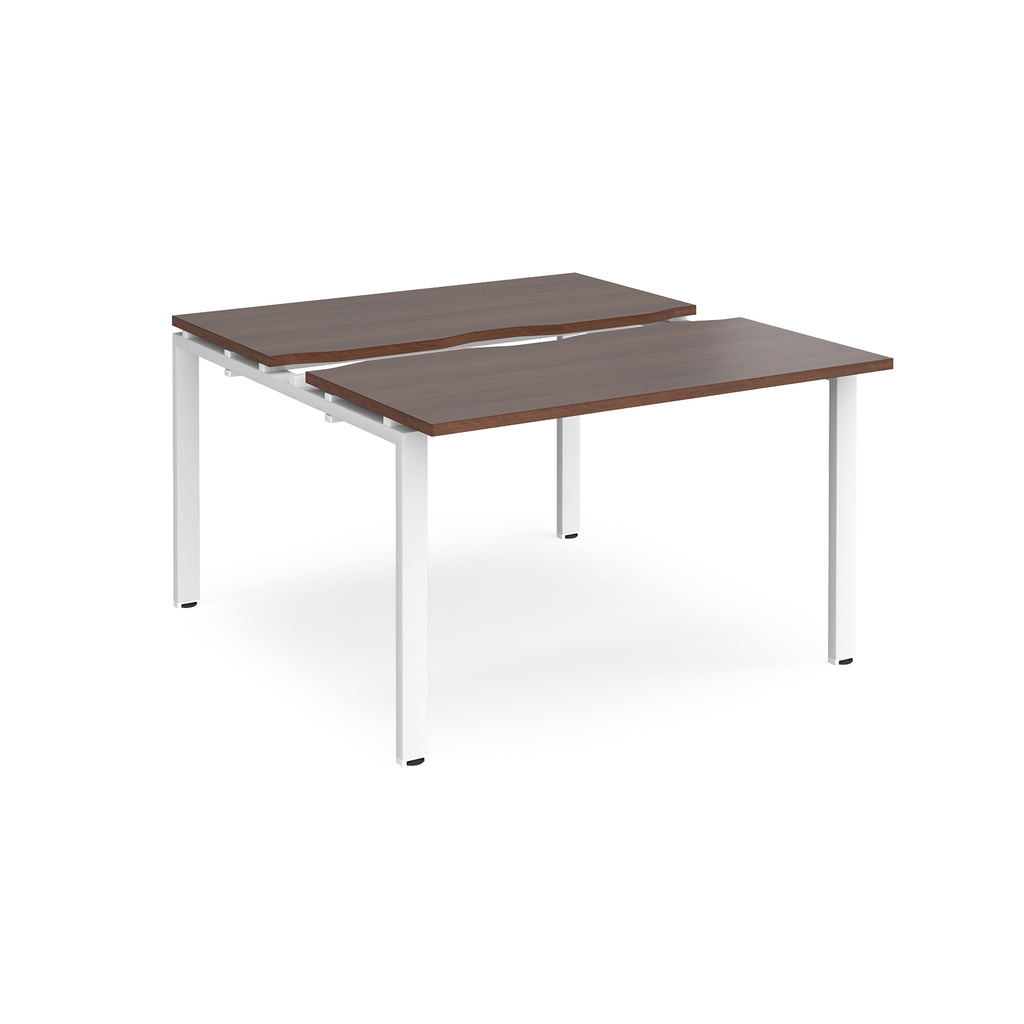Two-person back-to-back office desk with dark wood-effect worktops and white metal legs, shown against a white background.