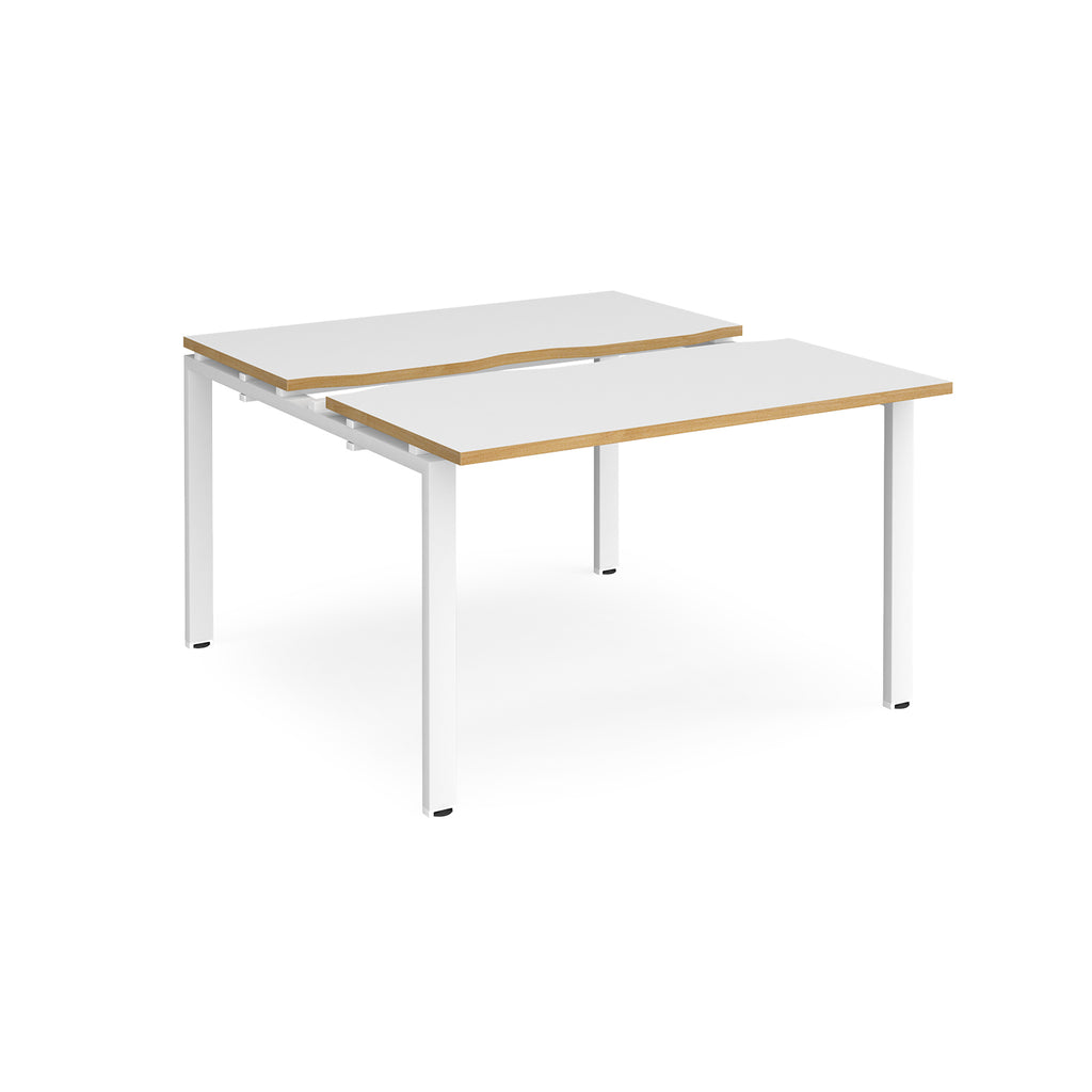 Two-person back-to-back office desk with white worktops, oak-effect edging, and white metal legs, shown against a white background.
