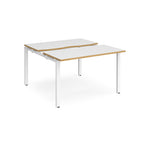 Two-person back-to-back office desk with white worktops, oak-effect edging, and white metal legs, shown against a white background.