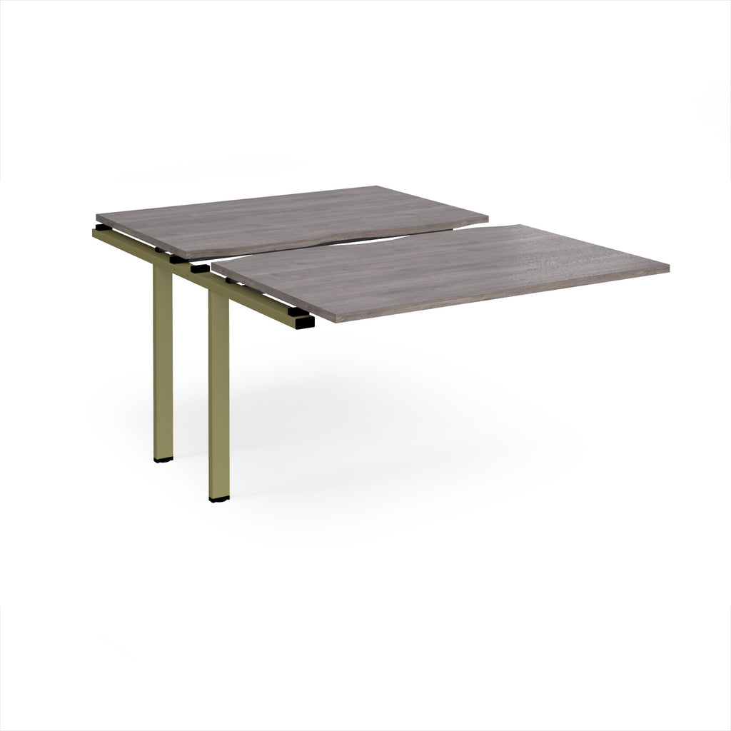 Large modular bench desk add-on with a grey wood-effect top and green metal legs, shown on a white background.