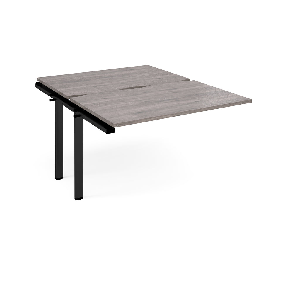 Large modular bench desk add-on with a grey wood-effect top and black metal legs, shown on a white background.