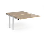 Large modular bench desk add-on with a wood-effect top and white metal legs, shown on a white background.