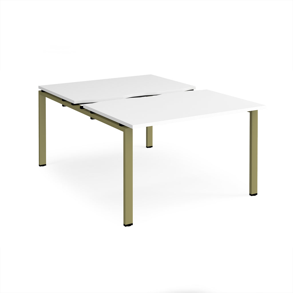 Large modular bench desk with a white worktop, integrated cable access cut-outs, and green metal legs, shown on a white background.