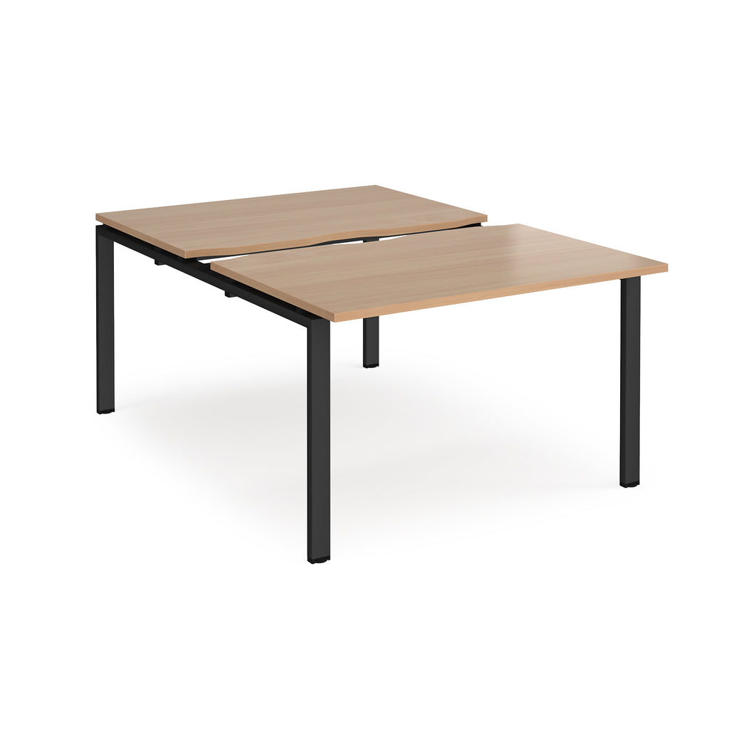 Large modular bench desk with a wood-effect top, integrated cable access cut-out, and black metal legs, shown on a white background.