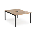 Large modular bench desk with a wood-effect top, integrated cable access cut-out, and black metal legs, shown on a white background.