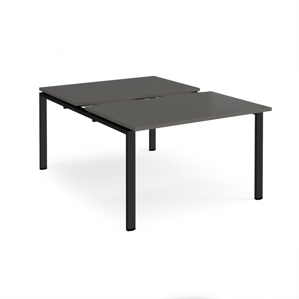 Large modular bench desk with a grey top, integrated cable access cut-out, and black metal legs, shown on a white background.
