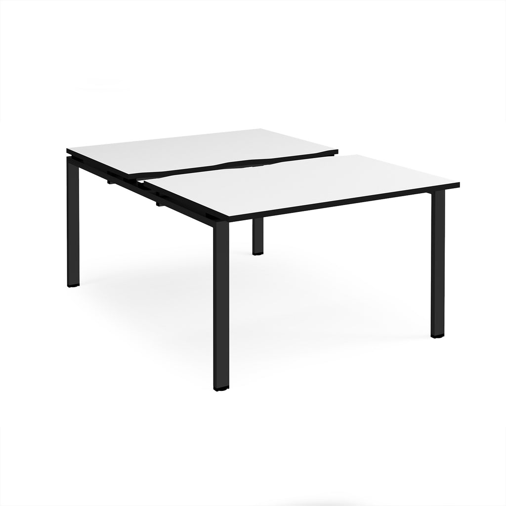 Large modular bench desk with white panels and black edging, integrated cable access cut-outs, and black metal legs, shown on a white background.