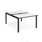 Large modular bench desk with white panels and black edging, integrated cable access cut-outs, and black metal legs, shown on a white background.