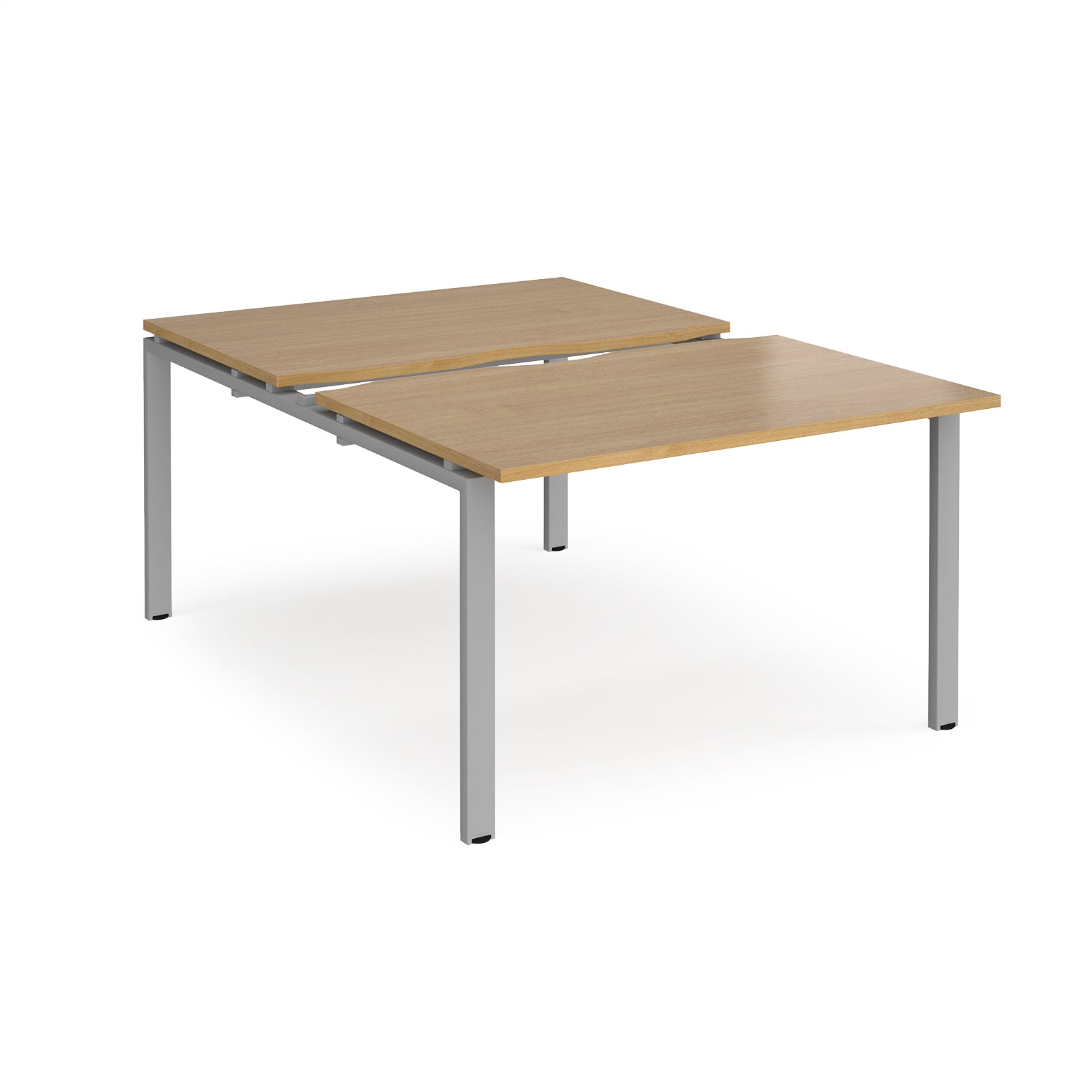 Large modular bench desk with a wood-effect top, integrated cable access cut-out, and silver metal legs, shown on a white background.
