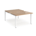 Large modular bench desk with a light wood-effect top, integrated cable access cut-outs, and white metal legs, shown on a white background.
