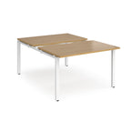 Large modular bench desk with a wood-effect top, integrated cable access cut-out, and white metal legs, shown on a white background.