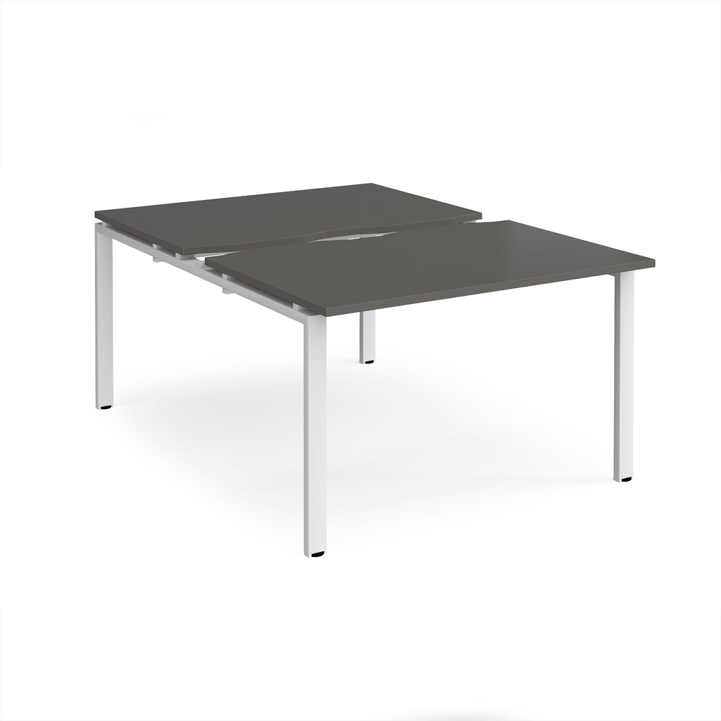 Large modular bench desk with a grey top, integrated cable access cut-out, and white metal legs, shown on a white background.