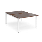 Large modular bench desk with a dark wood-effect top, integrated cable access cut-out, and white metal legs, shown on a white background.