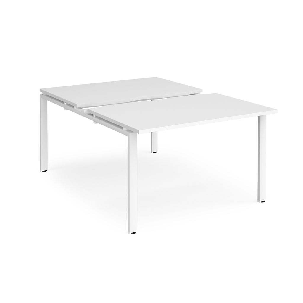 Large modular bench desk with a white top, integrated cable access cut-out, and white metal legs, shown on a white background.