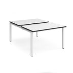 Large modular bench desk with white panels and black edging, integrated cable access cut-outs, and white metal legs, shown on a white background.