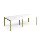 Large modular bench desk with a white worktop, integrated cable access cut-outs, and green metal legs, shown on a white background.