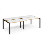 Large modular bench desk with white panels and wood-effect edging, integrated cable access cut-outs, and black metal legs, shown on a white background.