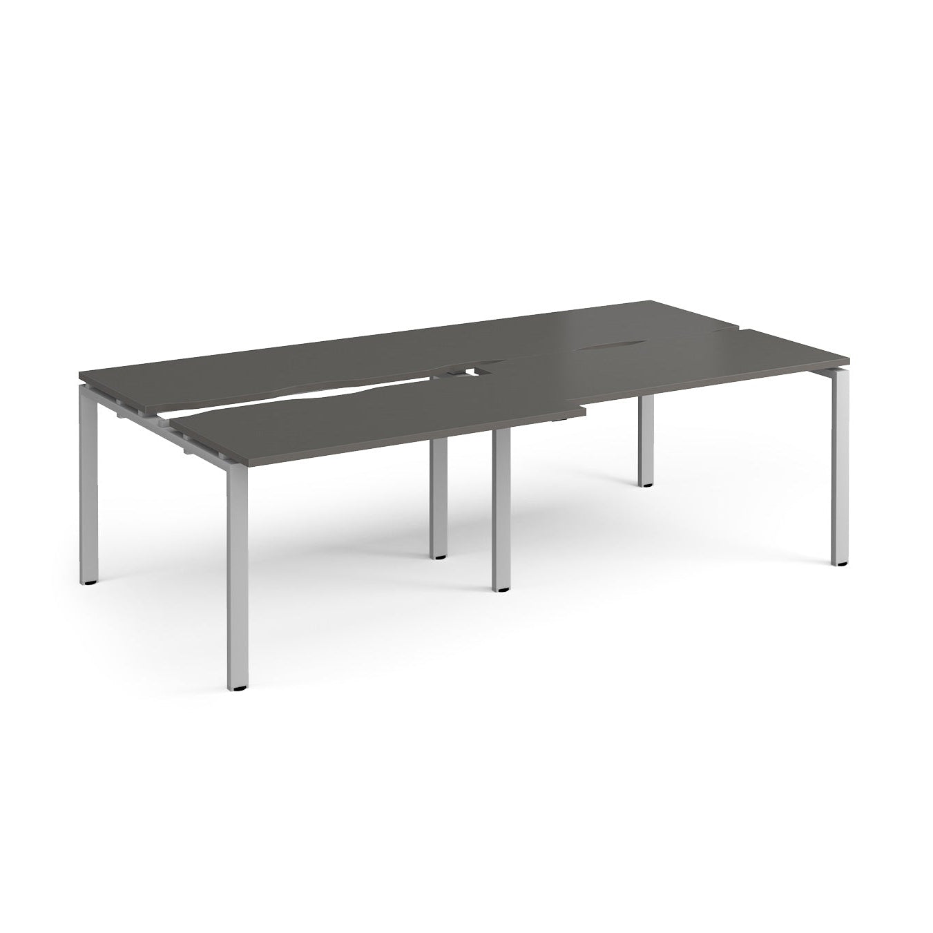 Large modular bench desk with a dark grey worktop, integrated cable access cut-outs, and silver metal legs, shown on a white background.
