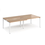 Large modular bench desk with a wood-effect top, integrated cable access cut-outs, and white metal legs, shown on a white background.