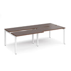 Large modular bench desk with a dark wood-effect top, integrated cable access cut-outs, and white metal legs, shown on a white background.