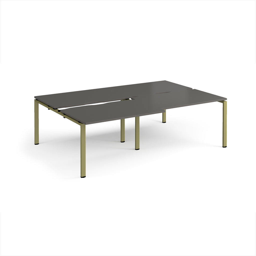 Large modular bench desk with a grey worktop, integrated cable access cut-outs, and green metal legs, shown on a white background.