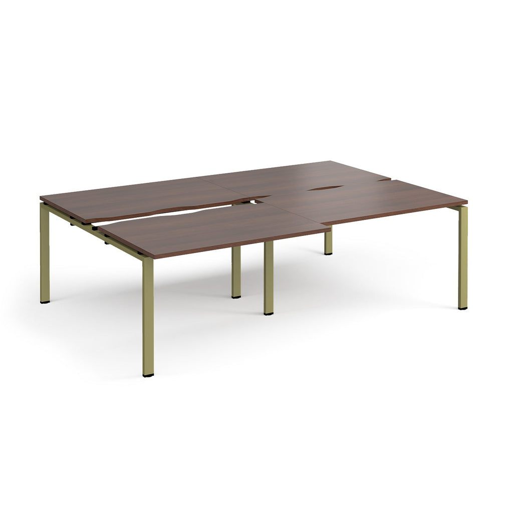 Large modular conference table with dark wood-effect panels, integrated cable cut-outs, and green metal legs, shown on a white background.