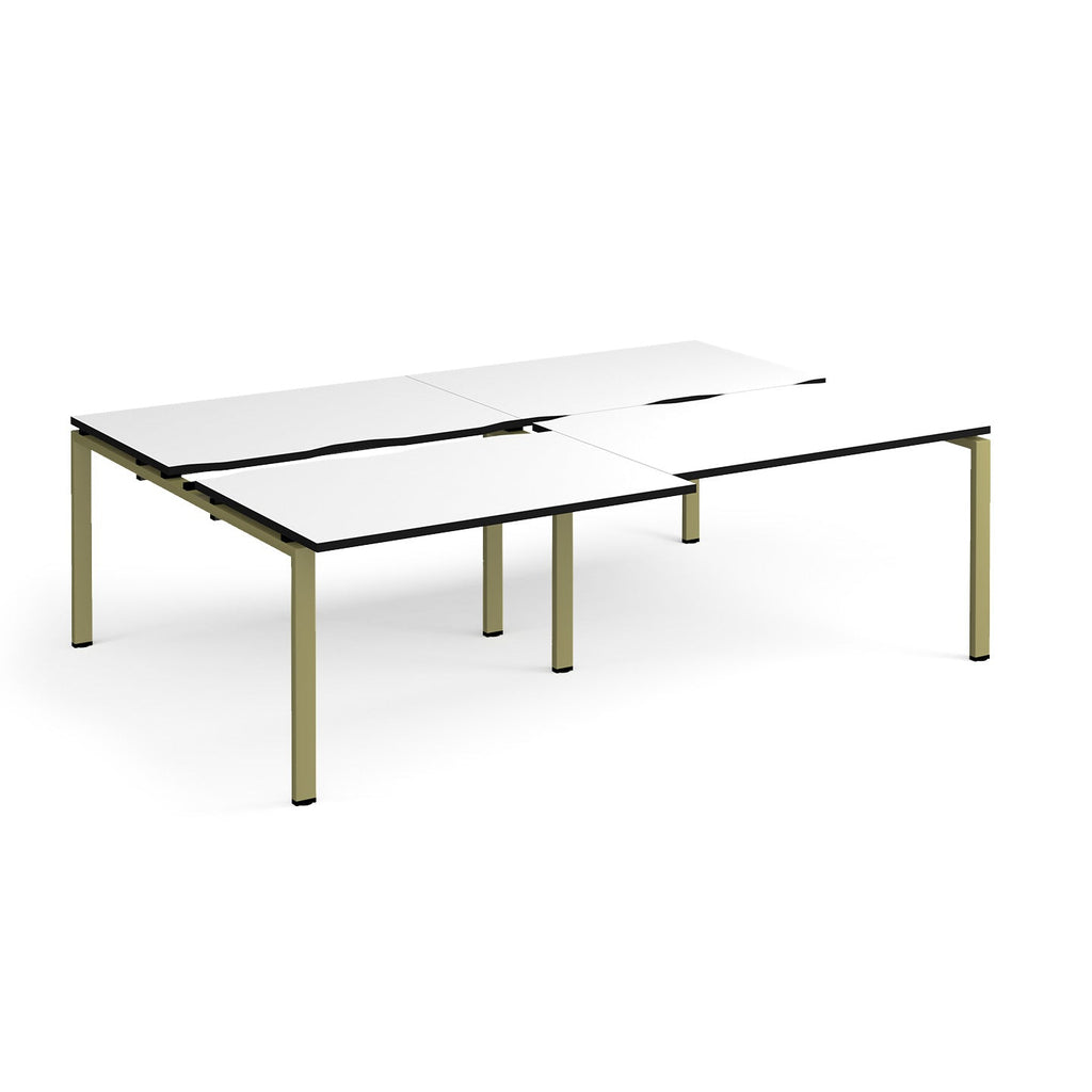 Large modular bench desk with a white worktop, contrasting black edge detail, integrated cable access cut-outs, and green metal legs, shown on a white background.