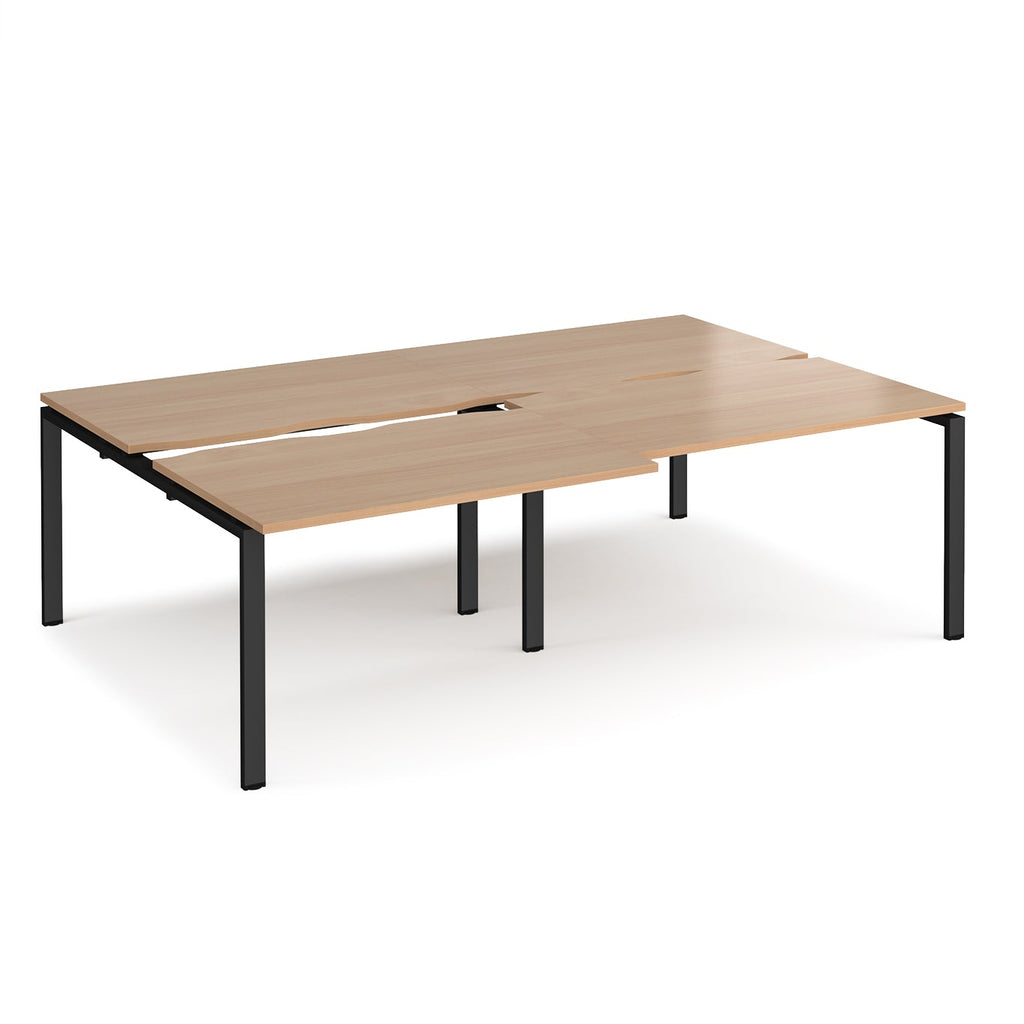 Large modular bench desk with a wood-effect top, integrated cable access cut-outs, and black metal legs, shown on a white background.