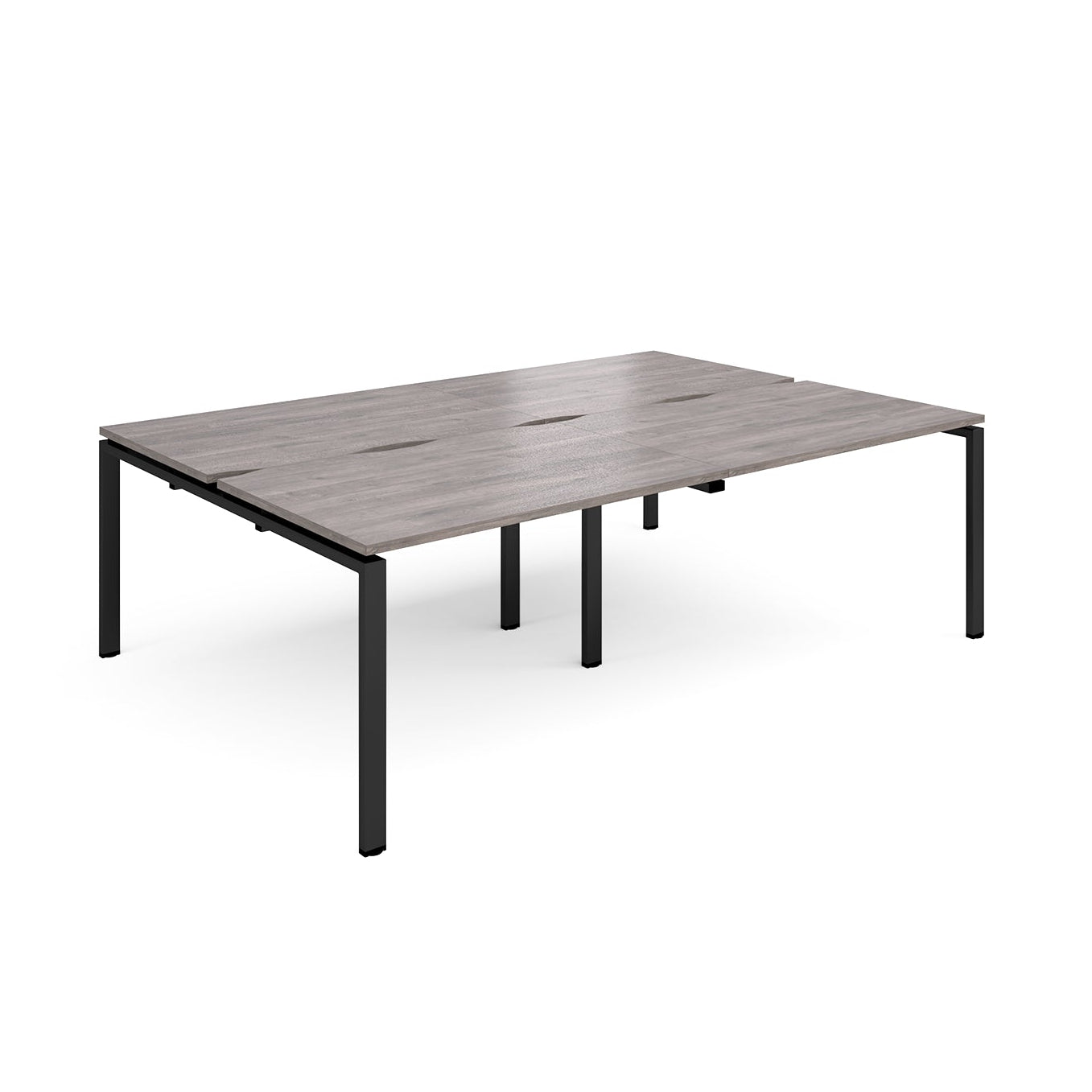 Large modular bench desk with a grey wood-effect top, integrated cable access slots, and black metal legs, shown on a white background.