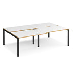 Large modular bench desk with white panels and wood-effect edging, integrated cable access cut-outs, and black metal legs, shown on a white background.