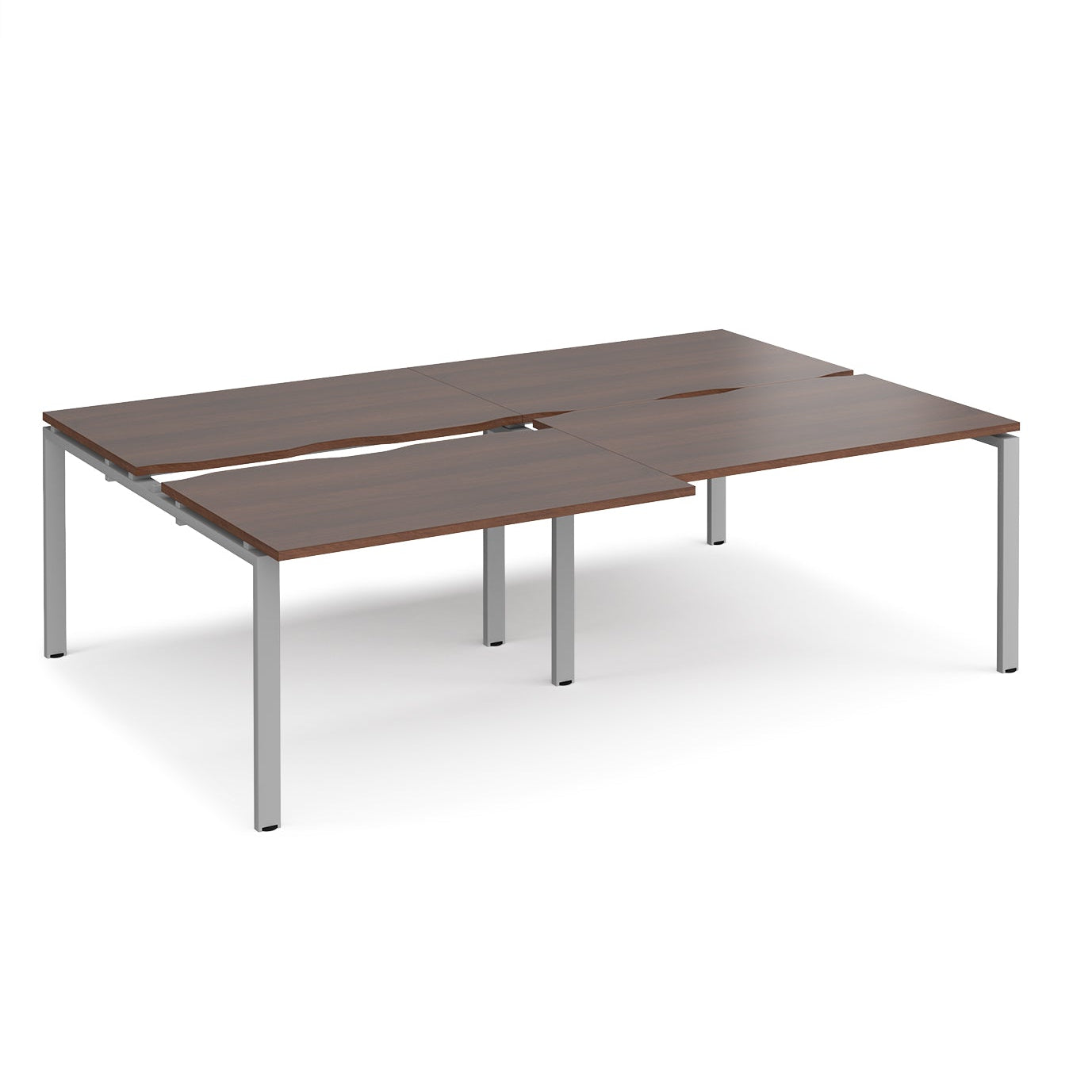 Large modular bench desk with a dark wood-effect top, integrated cable access cut-outs, and silver metal legs, shown on a white background.