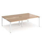 Large modular bench desk with a light wood-effect top, integrated cable access cut-outs, and white metal legs, shown on a white background.